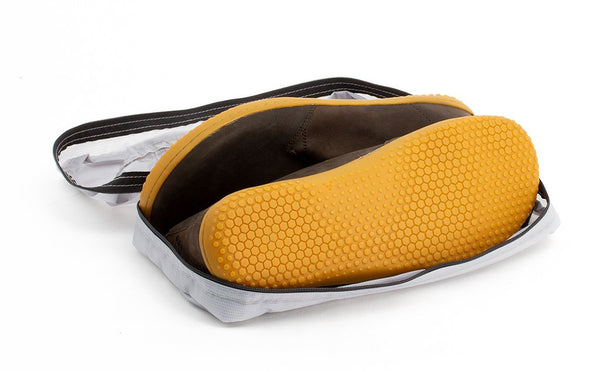 A pair of shoes in an open Northwest Sky (light grey) Aether End Pocket Packing Cube for the Aeronaut 30.